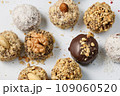 Set of round chocolate candies with nuts on a white background 109060520