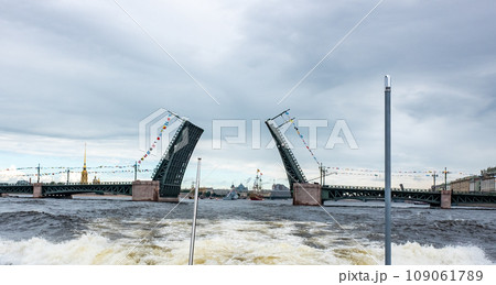 The divorced Palace Bridge across the Neva River in St. Petersburg on a cloudy summer day. 109061789
