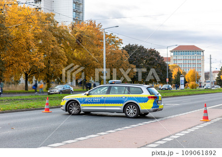 German Police car blocks road traffic at Dresden city street for safety reasons at demonstration protest activists meeting. Transportation drive closed blacked by policeman vehicle at Germany Saxony 109061892