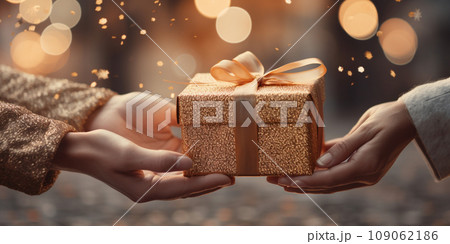 Hands of a woman with a New Year's gift box against a Christmas backdrop 109062186