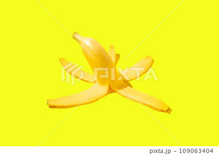 Peel of a ripe yellow banana on a yellow background 109063404