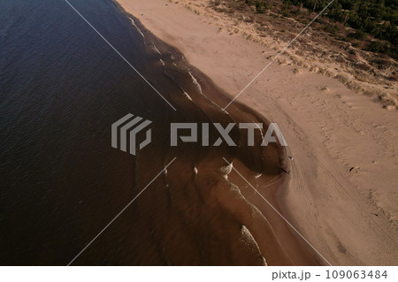 Drone aerial view of waves sea ocean coast. Beach and dunes dark calm sea waves nature landscape captured with drone. Tourism Drone aerial view of waves sea ocean coast. Beach and dunes dark calm sea waves nature landscape captured with drone. Tourism 109063484