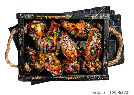 BBQ Chicken wings in Teriyaki sauce with black sesame in a tray. Isolated, white background. 109063780