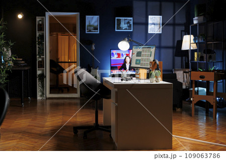 An empty newly opened workplace in a contemporary style is seen at night with desktop graphics active. A modern firm with no employees a new office layout indoor workspace. 109063786