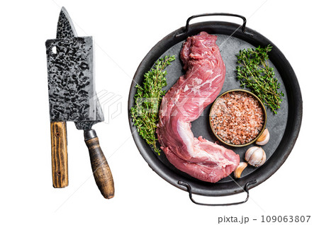 Uncooked Raw pork tenderloin fillet meat on a kitchet tray with thyme, garlic and sea salt. Isolated, white background. 109063807