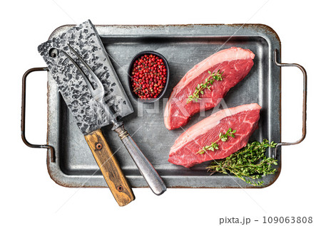 Top sirloin steak, raw beef meat steak with thyme and pepper on steel tray. Isolated, white background. 109063808