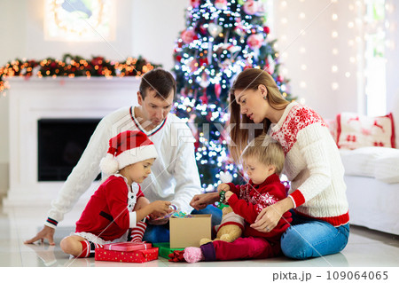 Family at Christmas tree. Parents and kids on Xmas Family at Christmas tree. Parents and kids on Xmas 109064065