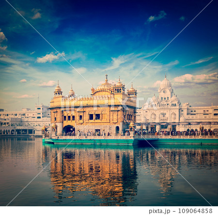 Vintage retro hipster style travel image of famous India attraction Sikh gurdwara Golden Temple (Harmandir Sahib). Amritsar, Punjab, India Vintage retro hipster style travel image of famous India attraction Sikh gurdwara Golden Temple (Harmandir Sahib). Amritsar, Punjab, India 109064858