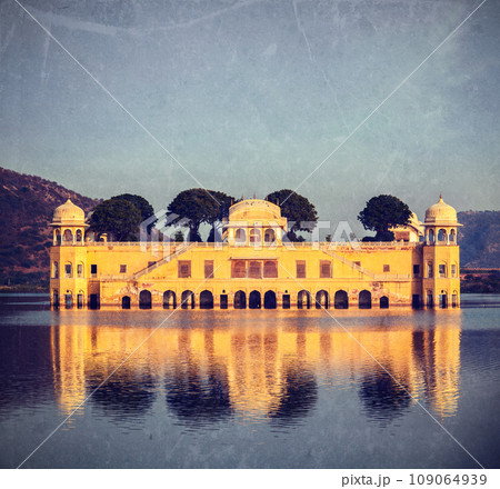 Vintage retro hipster style travel image of Rajasthan landmark - Jal Mahal (Water Palace) on Man Sagar Lake on sunset. Jaipur, Rajasthan, India with grunge texture overlaid Vintage retro hipster style travel image of Rajasthan landmark - Jal Mahal (Water Palace) on Man Sagar Lake on sunset. Jaipur, Rajasthan, India with grunge texture overlaid 109064939