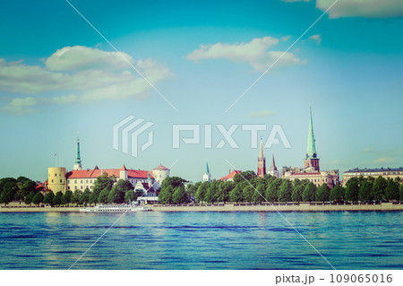 Vintage retro hipster style travel image of View of Riga over Daugava river: Riga Castle, St. James's Cathedral, St. Peter's Church. Riga, Latvia Vintage retro hipster style travel image of View of Riga over Daugava river: Riga Castle, St. James's Cathedral, St. Peter's Church. Riga, Latvia 109065016