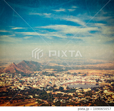 Vintage retro hipster style travel image of Holy city Pushkar aerial view from Savitri temple with grunge texture overlaid. Rajasthan, India Vintage retro hipster style travel image of Holy city Pushkar aerial view from Savitri temple with grunge texture overlaid. Rajasthan, India 109065057