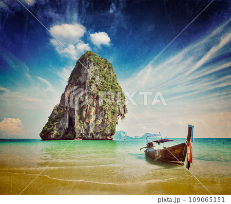 Retro vintage hipster style image of tropical vacation holiday beach concept - Long tail boat on tropical beach, Krabi, Thailand with grunge texture overlaid 109065151