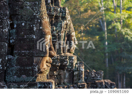 Ancient stone faces of Bayon temple, Angkor, Cambodia on sunset 109065160