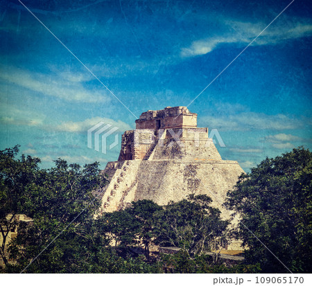 Vintage retro hipster style travel image of anicent mayan pyramid (Pyramid of the Magician, Adivino) in Uxmal, Merida, Yucat n, Mexico with grunge texture overlaid 109065170