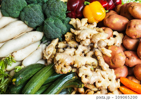Vegetables in Asian market close up - zucchini, Capsicum bell peppers, potatoes, ginger, broccoli cabbage, daikon white radish Vegetables in Asian market close up - zucchini, Capsicum bell peppers, potatoes, ginger, broccoli cabbage, daikon white radish 109065200