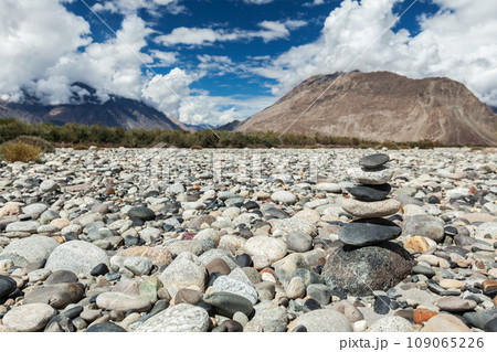 Zen balanced stones stack in Himalayas mountains. Nubra valley, Ladakh, Jammu and Kashmir, India Zen balanced stones stack in Himalayas mountains. Nubra valley, Ladakh, Jammu and Kashmir, India 109065226