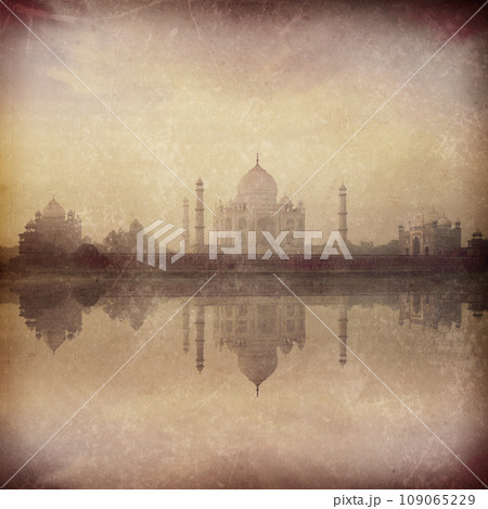 Vintage retro hipster style image of Taj Mahal on sunrise reflection in Yamuna river panorama in fog, Indian Symbol - India travel background with grunge texture overlaid. Agra, Uttar Pradesh, India 109065229