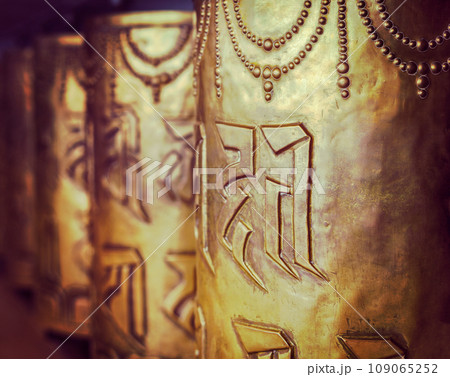 Vintage retro hipster style travel image of Tibetan Buddhist prayer wheels in Buddhism temple. Shallow depth of field. McLeod Ganj, HImachal Pradesh, India 109065252