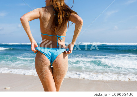 Beautiful young woman in sexy bikini at the beach 109065430