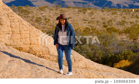 Young woman in a western style outfit exploring the amazing Red Rock Canyon in Nevada Young woman in a western style outfit exploring the amazing Red Rock Canyon in Nevada 109068309