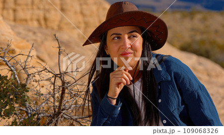 Portrait shot of a young cowgirl wearing a cowboy hat posing for the camera 109068326
