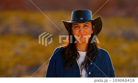 Portrait shot of a cowgirl in the desert at sunset 109068419