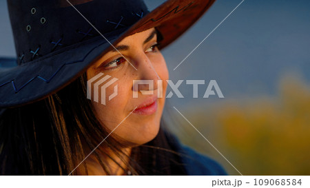 Close up shot of a young woman in a western style outfit in the Arizona desert Close up shot of a young woman in a western style outfit in the Arizona desert 109068584