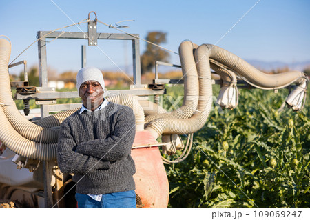 Man standing at fumigator on artichoke plantation 109069247