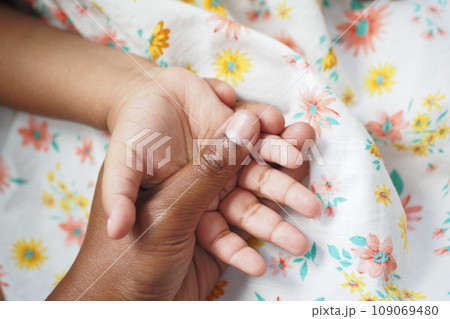 father holding hand of baby child,  109069480