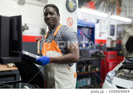 Automobile diagnosis. Car mechanic repairer looks for engine failure Automobile diagnosis. Car mechanic repairer looks for engine failure 109069964