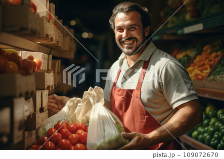 Mature grocery vendor holding paper bag with selection of fresh vegetables. Smiling Caucasian man wearing apron selling fresh organic food. Healthy organic products concept. 109072670