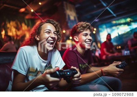 Close-up of two Caucasian teenage boys playing video games. Excited young gamers with joysticks in their hands are passionate about game and having real fun. Entertainment and gaming for kids concept. Close-up of two Caucasian teenage boys playing video games. Excited young gamers with joysticks in their hands are passionate about game and having real fun. Entertainment and gaming for kids concept. 109072988