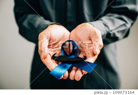 November, Prostate Cancer Awareness Month, A Blue Ribbon with a mustache symbolizes support for those facing illness. Ideal for healthcare, International Men's Day, and World Cancer Day concepts. 109073164