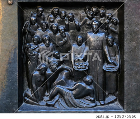 Give us today our daily bread - feeding the 5000, relief on the door of the Grossmunster ("great minster") church in Zurich, Switzerland 109075960