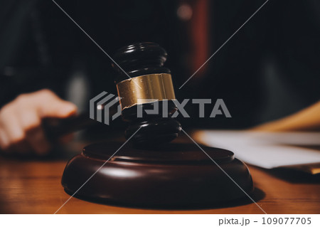 law books and scales of justice on desk in library of law firm. jurisprudence legal education concept. law books and scales of justice on desk in library of law firm. jurisprudence legal education concept. 109077705