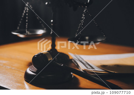 law books and scales of justice on desk in library of law firm. jurisprudence legal education concept. law books and scales of justice on desk in library of law firm. jurisprudence legal education concept. 109077710