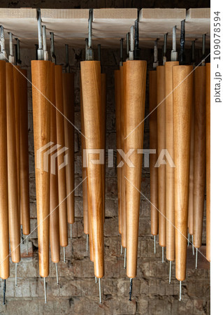 Set of wooden furniture legs drying after applying varnish 109078594