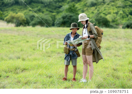 Group family children checking map in the jungle adventure.  109078751