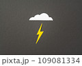 White cut out paper cloud and yellow lightning on black 109081334