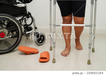 Asian woman injury from falling down on slippery surfaces with walker at home. Asian woman injury from falling down on slippery surfaces with walker at home. 109083264