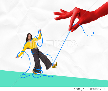 Poster. Contemporary art collage. Huge arm fingers hold, manipulate strings girl like puppet against crumpled paper background. 109083787