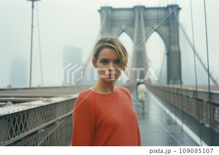 Pretty young woman taking a selfie on Brooklyn Bridge - Female tourist sightseeing New York 109085107