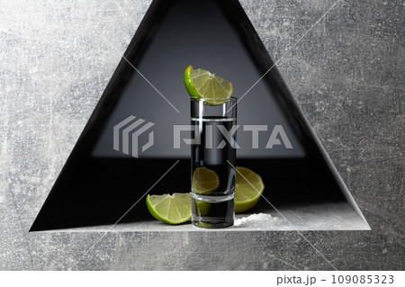 Tequila with lime slices and sea salt. 109085323