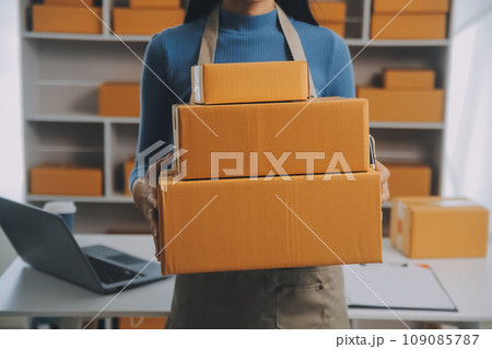 Business woman start up small business entrepreneur SME success .freelance woman working at home with Online Parcel delivery. SME and packaging deliveryconcept Business woman start up small business entrepreneur SME success .freelance woman working at home with Online Parcel delivery. SME and packaging deliveryconcept 109085787