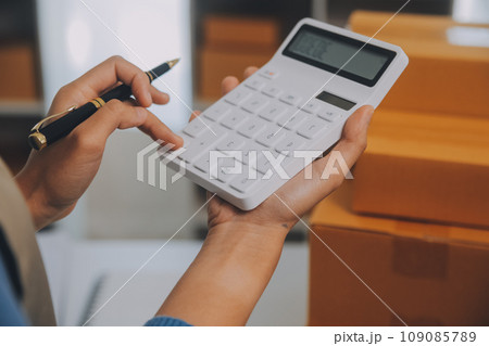 Business woman start up small business entrepreneur SME success .freelance woman working at home with Online Parcel delivery. SME and packaging deliveryconcept Business woman start up small business entrepreneur SME success .freelance woman working at home with Online Parcel delivery. SME and packaging deliveryconcept 109085789