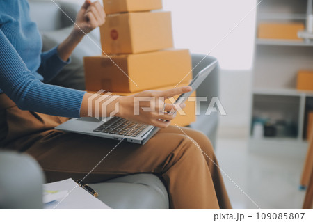 Business woman start up small business entrepreneur SME success .freelance woman working at home with Online Parcel delivery. SME and packaging deliveryconcept 109085807