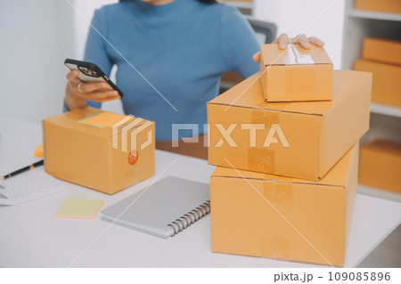 Business woman start up small business entrepreneur SME success .freelance woman working at home with Online Parcel delivery. SME and packaging deliveryconcept Business woman start up small business entrepreneur SME success .freelance woman working at home with Online Parcel delivery. SME and packaging deliveryconcept 109085896