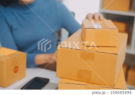 Business woman start up small business entrepreneur SME success .freelance woman working at home with Online Parcel delivery. SME and packaging deliveryconcept Business woman start up small business entrepreneur SME success .freelance woman working at home with Online Parcel delivery. SME and packaging deliveryconcept 109085898