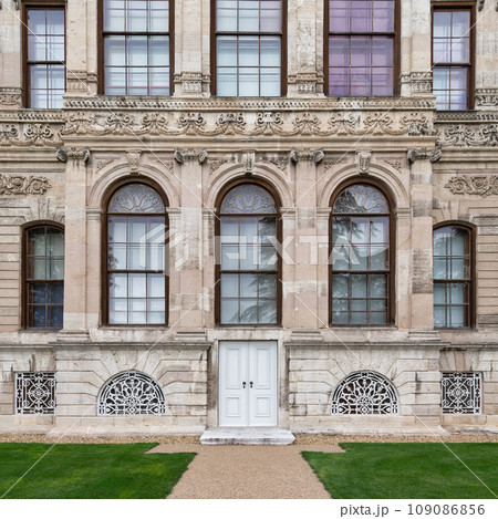 Side wall at Dolmabahce Palace, with small door and arched windows, Besiktas district, Bosphorus, Istanbul, Turkey 109086856