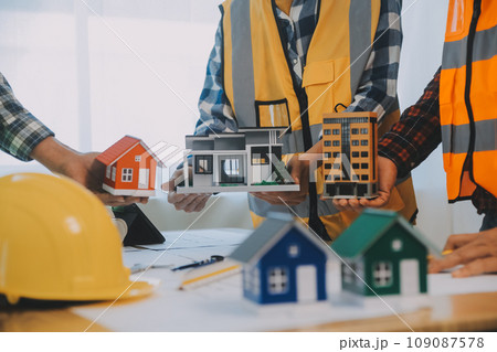 Construction and structure concept of Engineer or architect meeting for project working with partner and engineering tools on model building and blueprint in working site, contract for both companies. 109087578